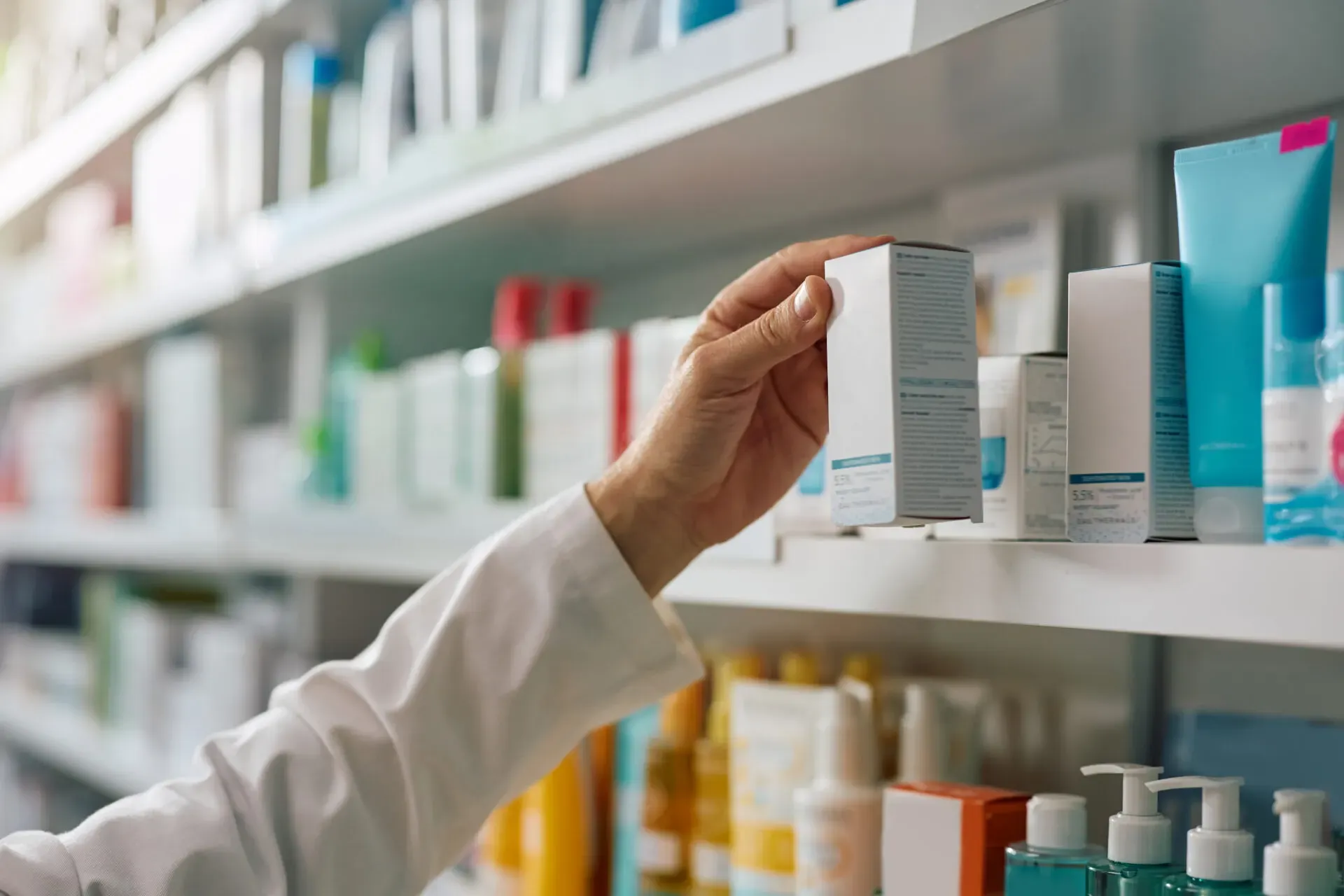 Pharmacist checking boxes of medicine on a shelf, Pan Pharmacy Birmingham