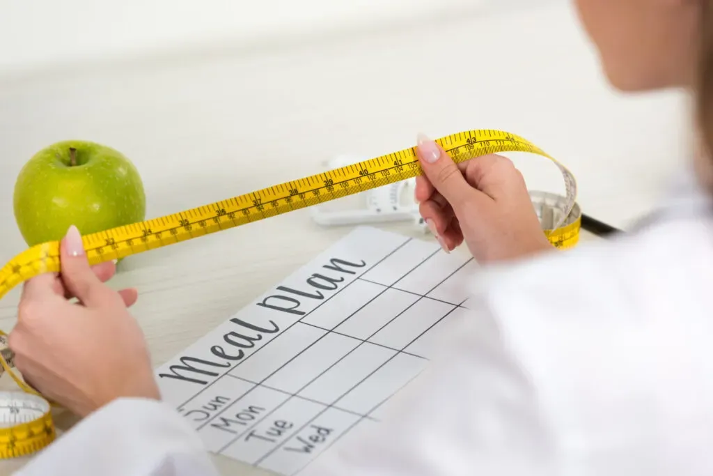 Dietitian holding a measuring tape at Pan Pharmacy Birmingham
