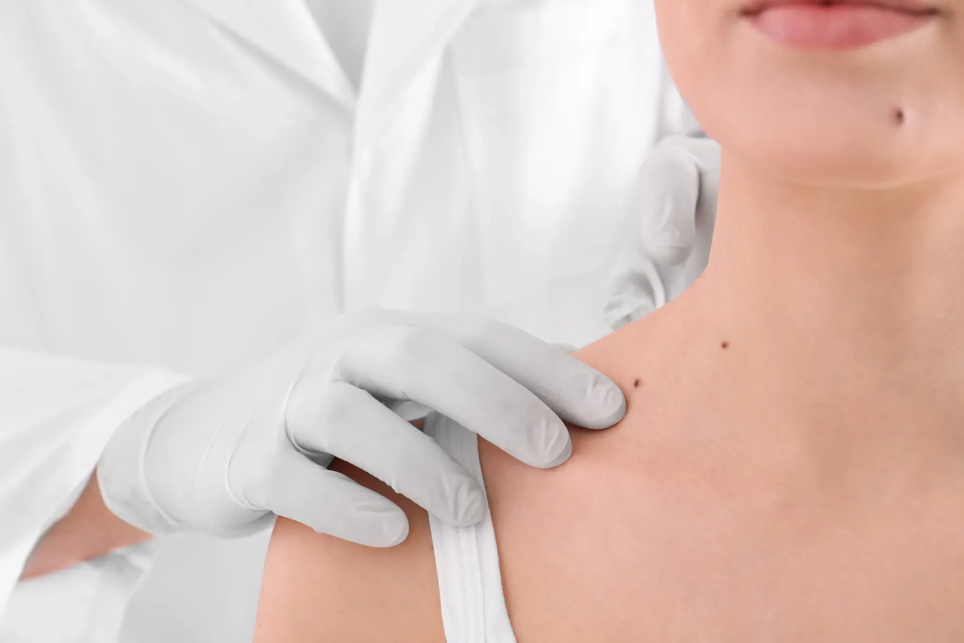 Clinician examining a patient's skin close up at Pan Pharmacy Birmingham