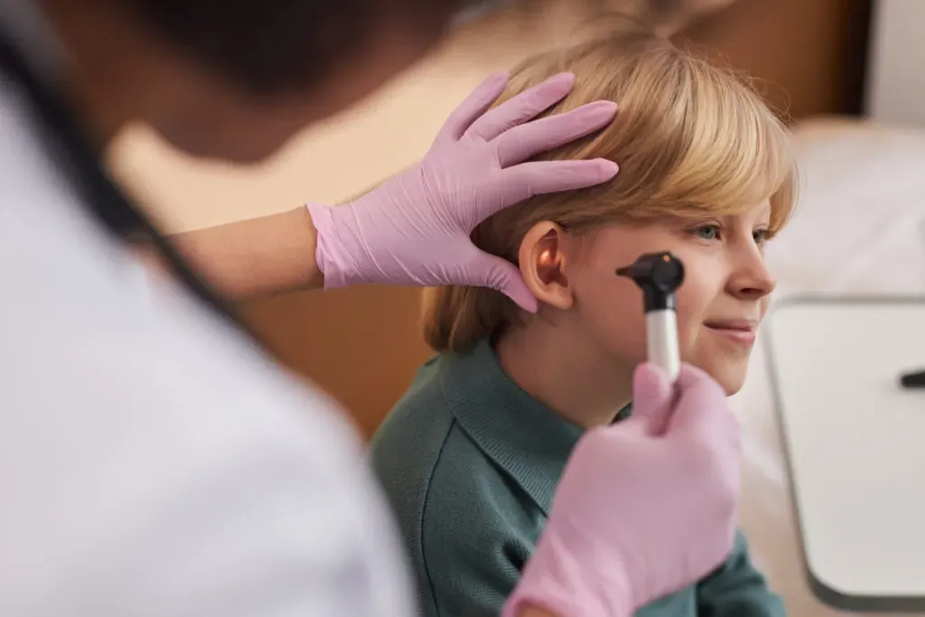 Clinician checking a child's ears and hearing at Pan Pharmacy Birmingham