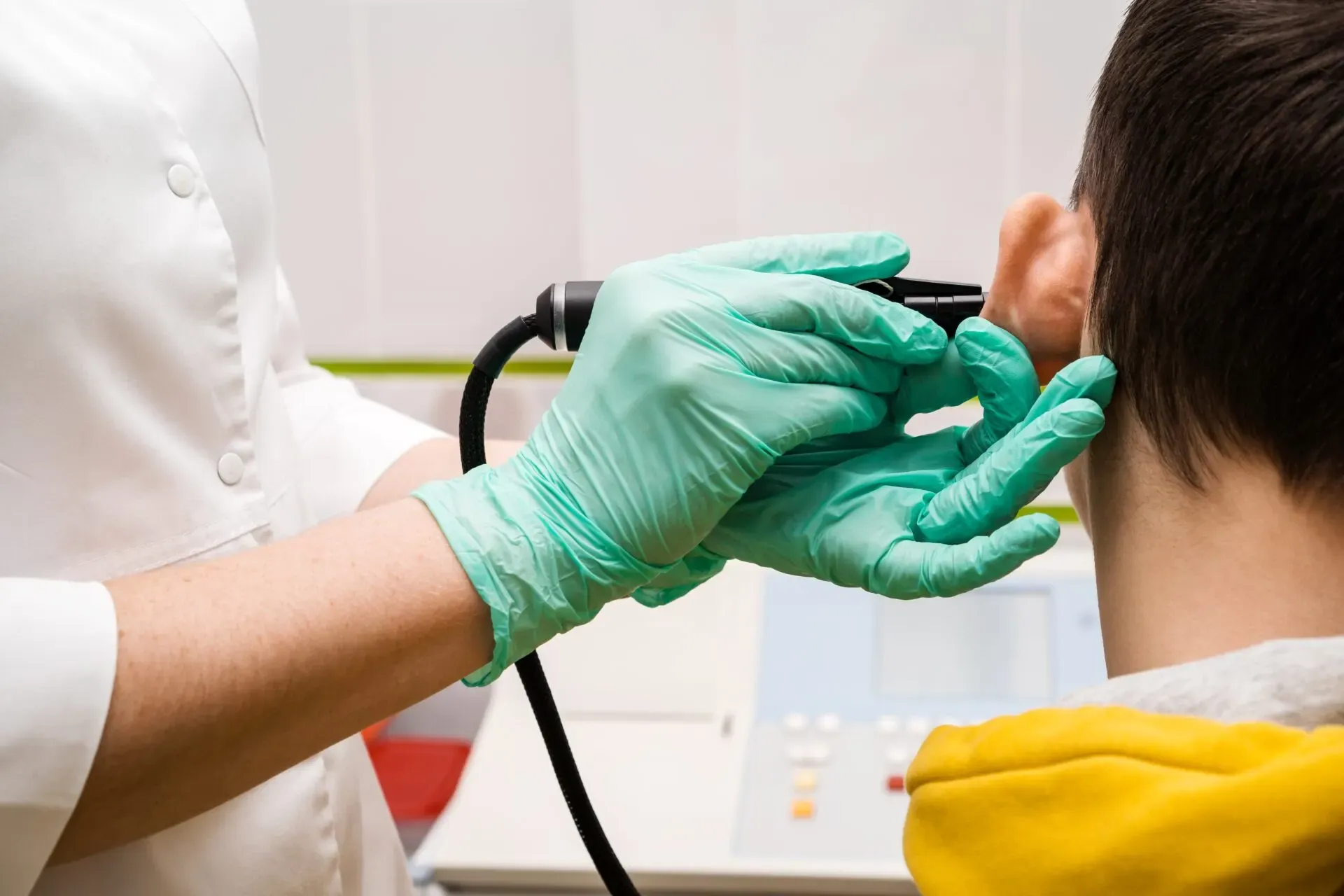 Clinician examining a patient's ear before ear wax removal at Pan Pharmacy Birmingham