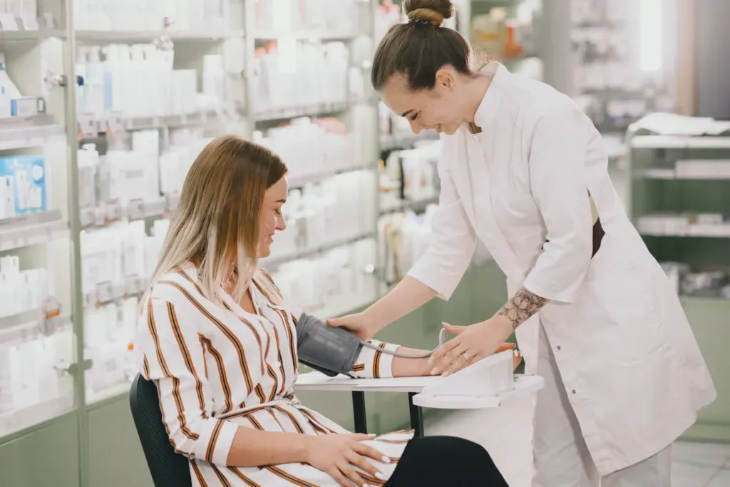 Pharmacist taking a customer’s blood pressure at Pan Pharmacy Birmingham